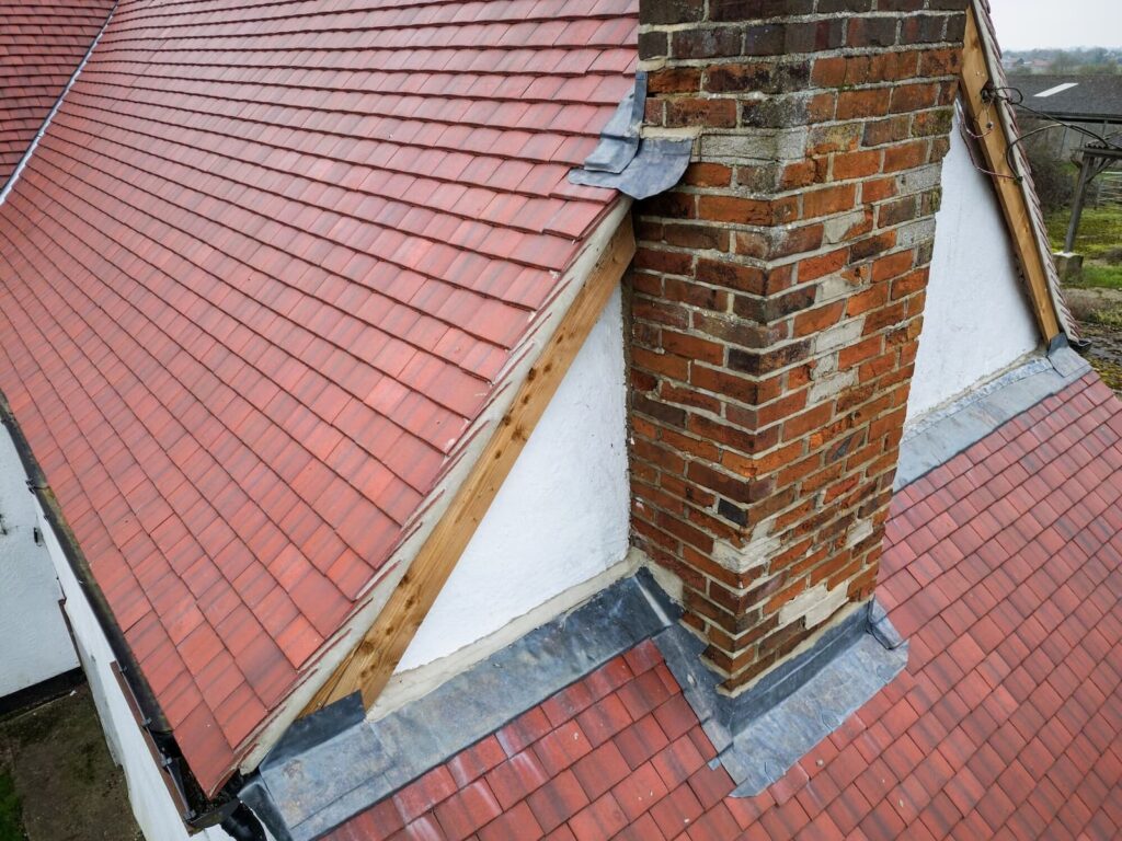 Leadwork and chimney repairs on a tiled roof